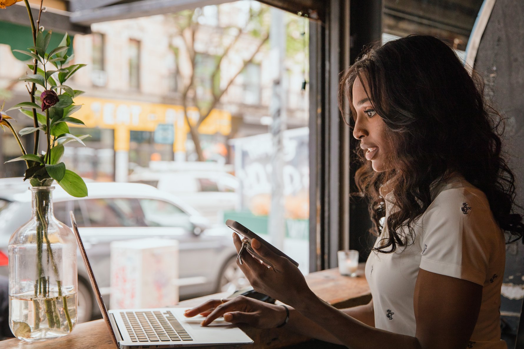 Businesswoman Working on Laptop in Cafe
